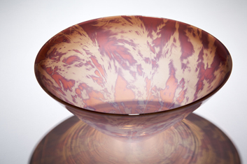 Toetoe Bowl - A blown glass object from photosensitive glass with color overlay. The imagery is created by the