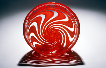 Red Swirly Bowl - A beautiful bowl in the family of pattern themed objects	featuring a swirly motif.

TECHNIQUE 
blown glass /